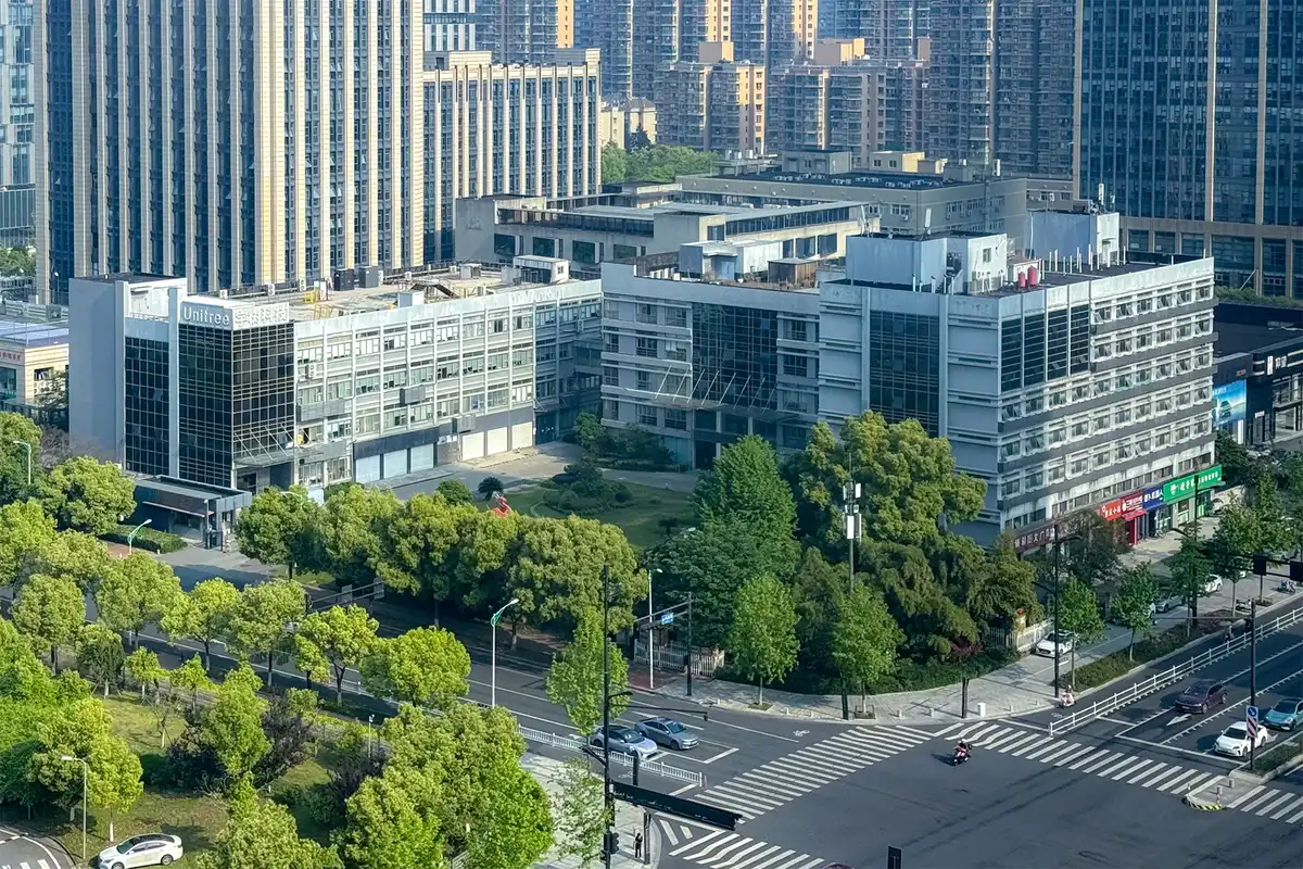 Vista aérea del edificio corporativo de Unitree entre torres urbanas de la ciudad